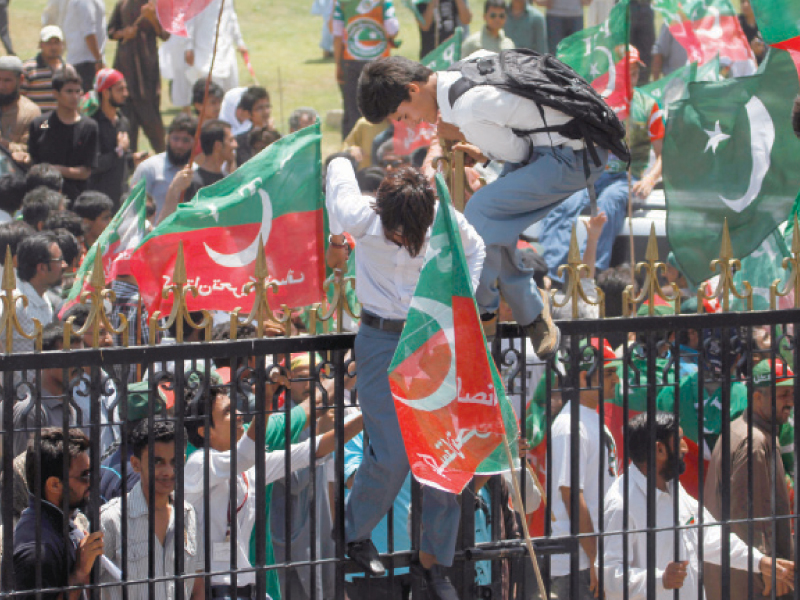 pti supporters climb over the locked gates to enter quaid s mausoleum photo ayesha mir express