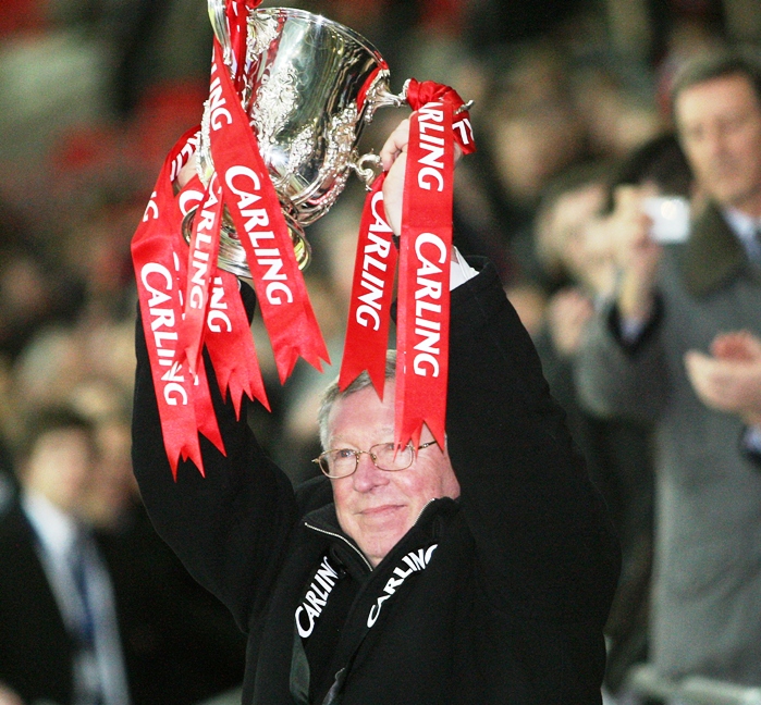 in this file picture taken on march 1 2009 manchester united 039 s manager alex ferguson celebrates with the trophy after his team beat tottenham to win the 2009 carling cup final at wembley stadium in north london photo afp