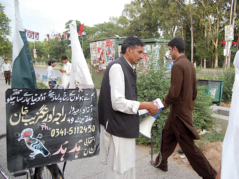 khan has been running his campaign all by the himself and he uses his bicycle to spread his message photo muhammad javaid express