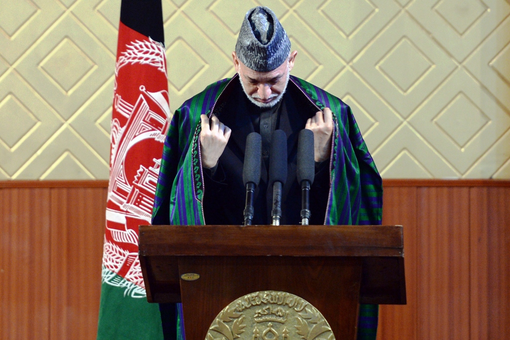 afghan president hamid karzai prepares to deliver his address during a ceremony to mark the 80th anniversary of kabul university in kabul on may 9 2013 photo afp