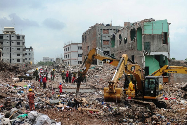 bangladeshi army personnel stand as they continue the second phase of the rescue operation using heavy equipment after an eight storey building collapsed in savar photo afp bangladeshi army personnel stand as they continue the second phase of the rescue operation using heavy equipment after an eight storey building collapsed in savar photo afp