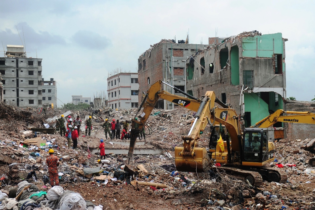 bangladeshi army personnel stand as they continue the second phase of the rescue operation using heavy equipment after an eight storey building collapsed in savar photo afp