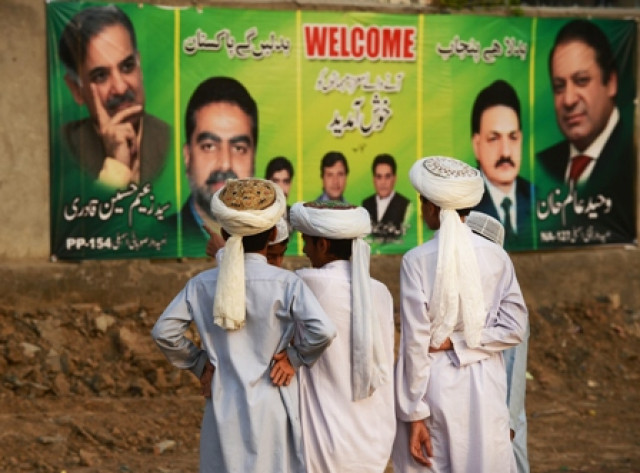young supporters of the pmln stand near political posters during a political rally in lahore may 9 2013 photos afp young supporters of the pmln stand near political posters during a political rally in lahore may 9 2013 photos afp