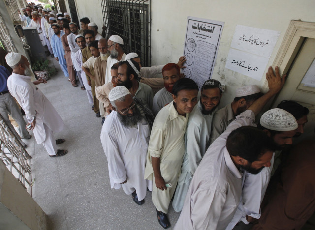voters line up as they wait for their turn to cast their vote at a polling station in karachi photo retuers voters line up as they wait for their turn to cast their vote at a polling station in karachi photo retuers