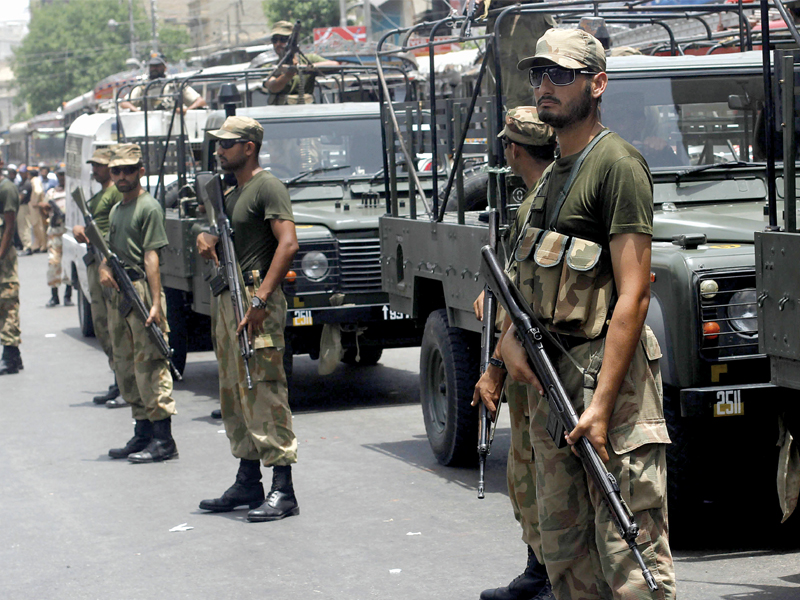 soldiers stand on guard across na 250 photo athar khan express