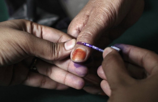 an election official marks a voter 039 s thumb with ink for identification as she gets a ballot paper before casting her vote photo reuters an election official marks a voter 039 s thumb with ink for identification as she gets a ballot paper before casting her vote photo reuters