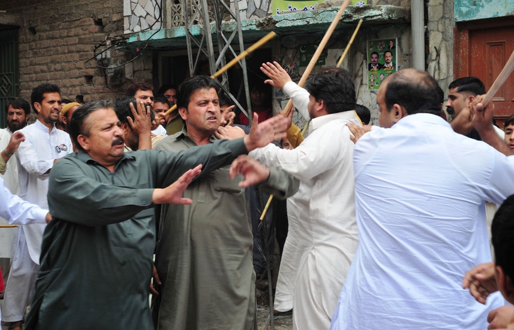 pakistani political party activists clash near a womens polling station after an incident during voting for the general election in rawalpindi on may 11 2013 photo afp