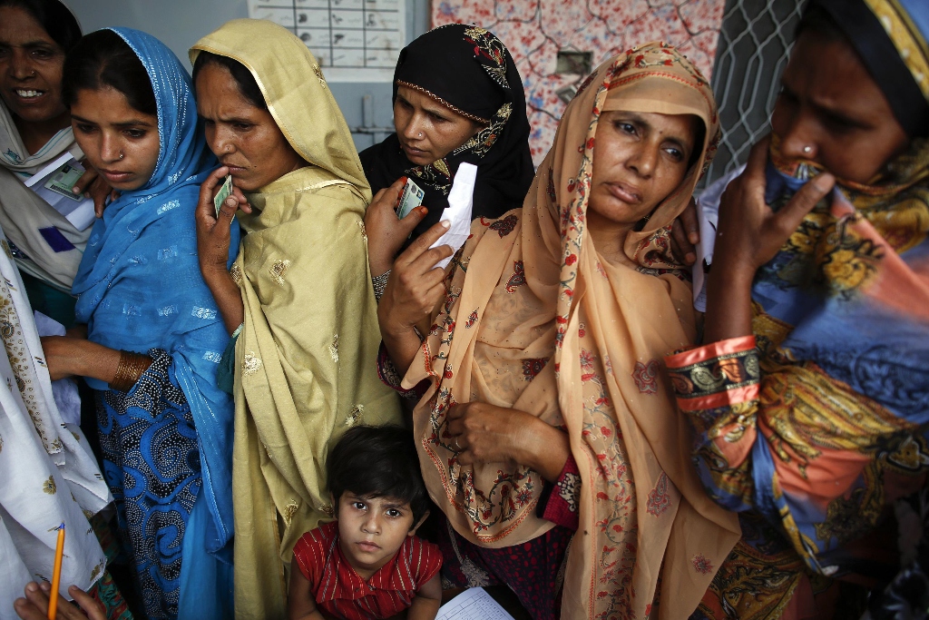 women wait to vote at a polling station in a village near lahore may 11 2013 photo reuters