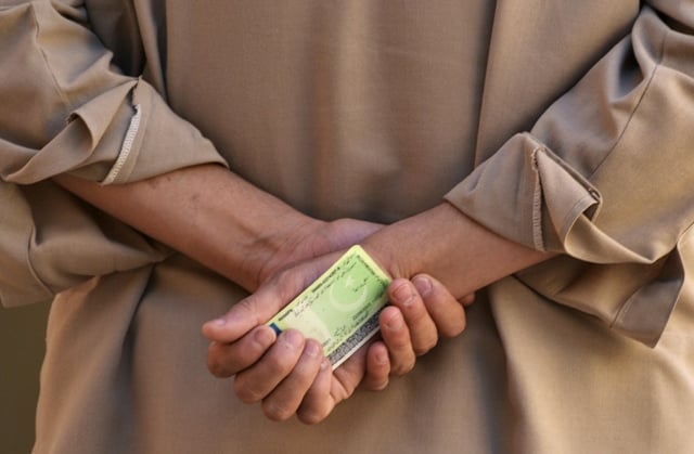 a voter holds his computerised national identity card cnic as he waits to cast his vote at a polling station in quetta may 11 2013 photo reuters