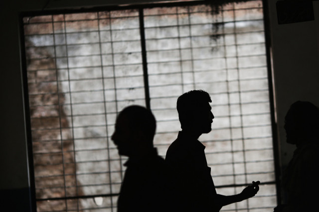 men chat inside a school turned into a polling station in the old part of lahore may 11 2013 photo reuters men chat inside a school turned into a polling station in the old part of lahore may 11 2013 photo reuters