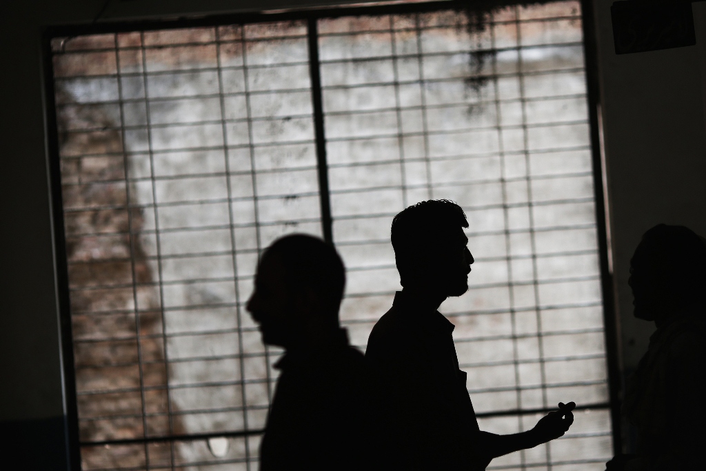 men chat inside a school turned into a polling station in the old part of lahore may 11 2013 photo reuters