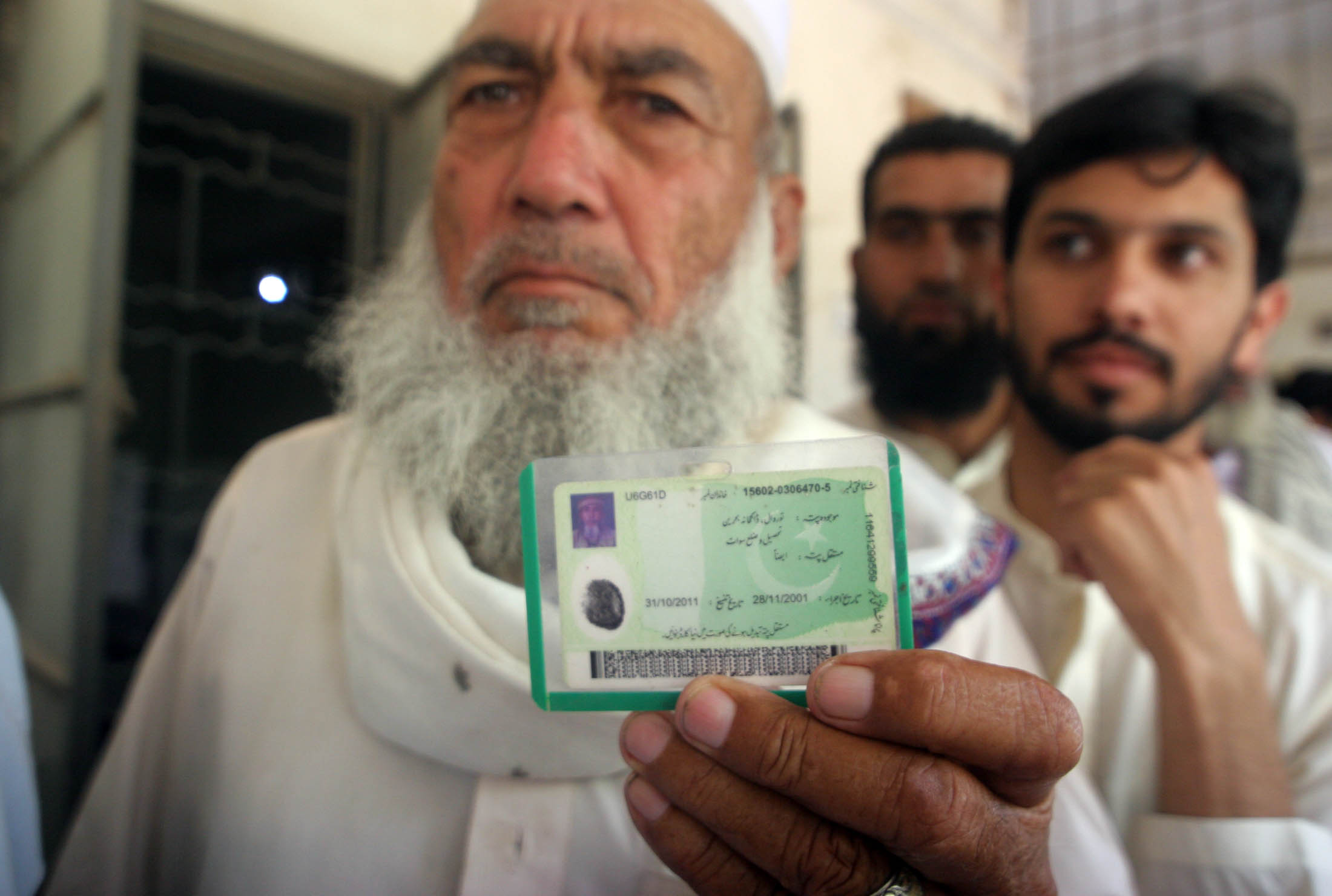 a man is seen holding his nic while waiting in line to vote photo athar khan