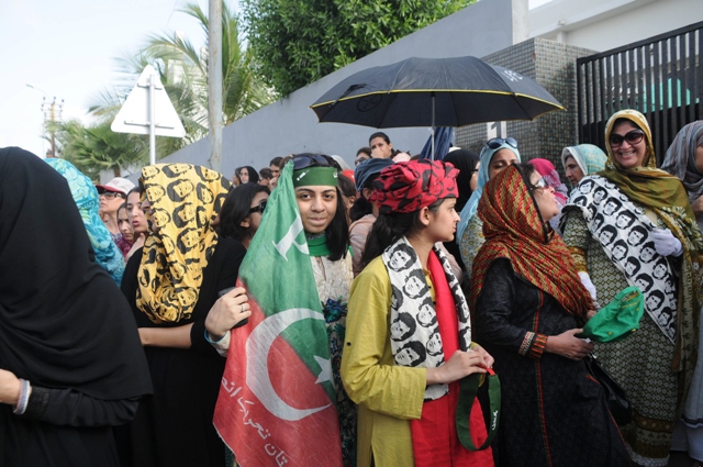 women wait outside dha model school in phase 4 to exercise their right to vote but the polling station was not opened at its stipulated time photo mohammad noman express