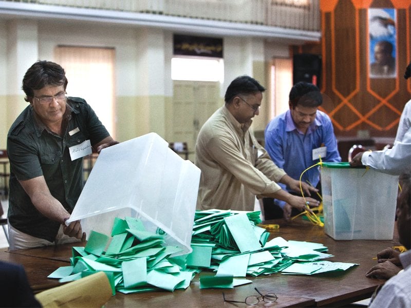 officers empty ballot boxes in readiness to start tallying votes photo afp reuters muhammad javaid myra iqbal zafar aslam