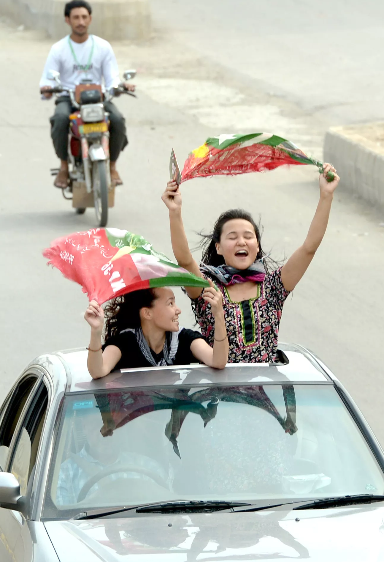 activists of pakistan tehreek e insaf pti wave party flags as they drive through the streets during the general election in rawalpindi on may 11 2013 photo afp activists of pakistan tehreek e insaf pti wave party flags as they drive through the streets during the general election in rawalpindi on may 11 2013 photo afp