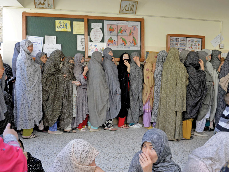female voters of the hazara community line up to cast their votes photo afp