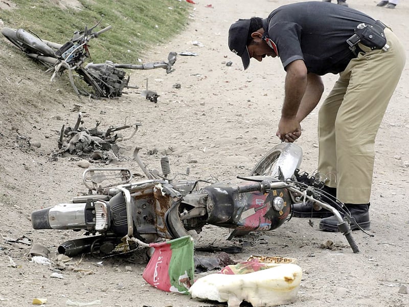 the charred remains of a bomb laden motorbike after an attack targeting a women polling station on charsadda road photo inp