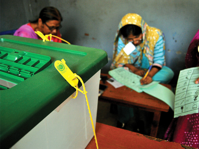 a woman waiting to cast her vote for the provincial assembly seat in lyari photo arif soomro express a woman waiting to cast her vote for the provincial assembly seat in lyari photo arif soomro express