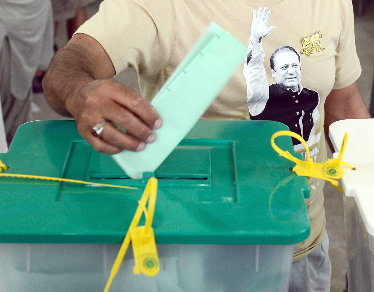 a supporter of former pakistani prime minister nawaz sharif casts his vote at a polling station in lahore on may 11 2013 photo afp
