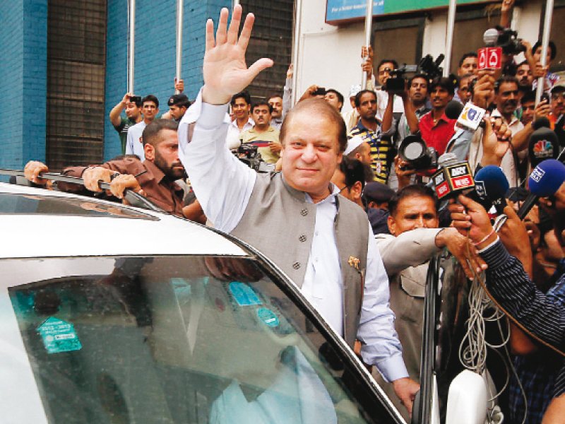 nawaz sharif waves to supporters as he heads off to vote at na 119 on saturday morning