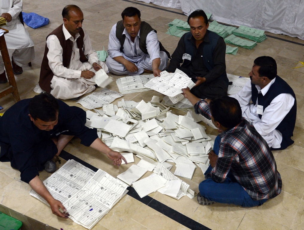 election officials count ballot papers at the end of polling in quetta on may 11 2013 photo afp