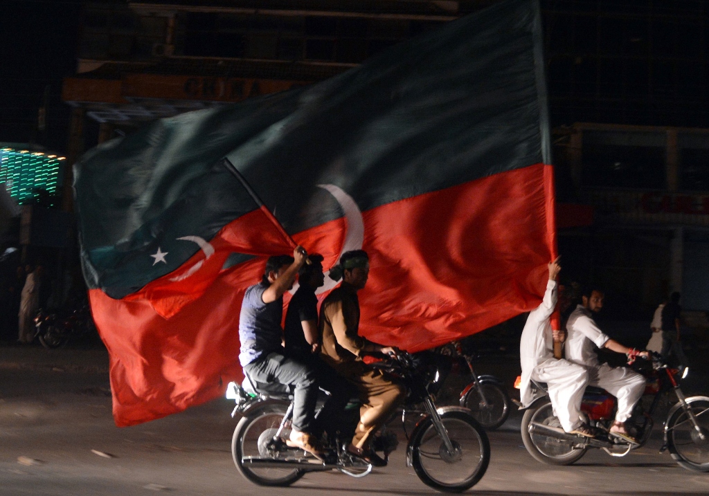 pti supporters carry their party flags as they take part in a rally in rawalpindi on may 12 2013 photo afp