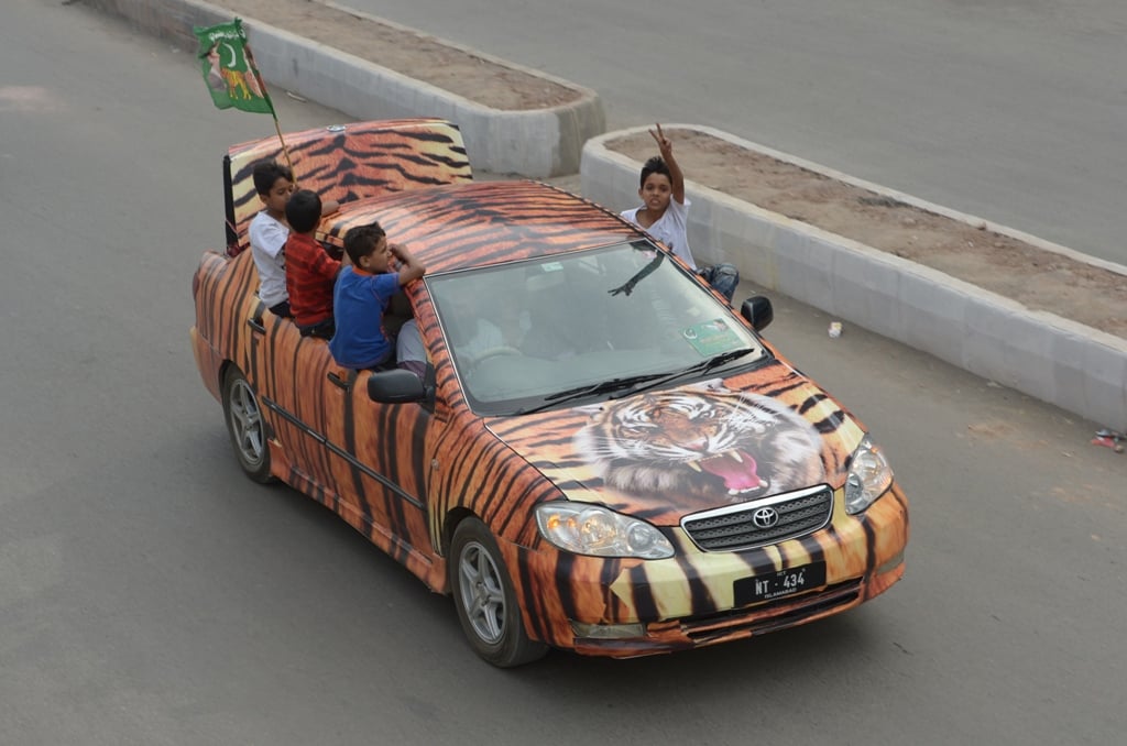 supporters of pakistan muslim league nawaz pml n drive through the streets during the general election in rawalpindi on may 11 2013 photo afp