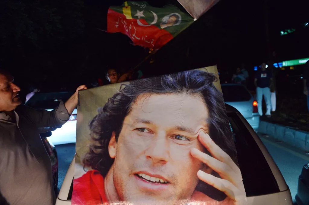 a pti supporter carries imran khan 039 s portrait as they take part in a rally in islamabad on may 11 2013 photo afp a pti supporter carries imran khan 039 s portrait as they take part in a rally in islamabad on may 11 2013 photo afp