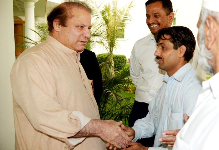 former pakistani prime minister and head of the pakistan muslim league n pml n nawaz sharif l meets party supporters at his residence in lahore on may 12 2013 photo afp
