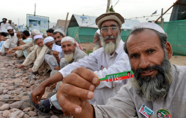 a pti supporter sits in a queue waiting for his turn to cast vote outside a polling station in jalozai camp on saturday photo afp a pti supporter sits in a queue waiting for his turn to cast vote outside a polling station in jalozai camp on saturday photo afp