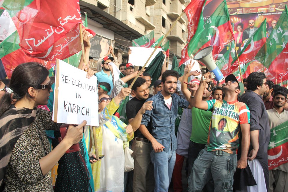 in karachi pti activists defied the section 144 imposed by the government and gathered in their hundreds to block the shahrah e faisal in presence of heavily armed police and rangers photo ayesha mir express