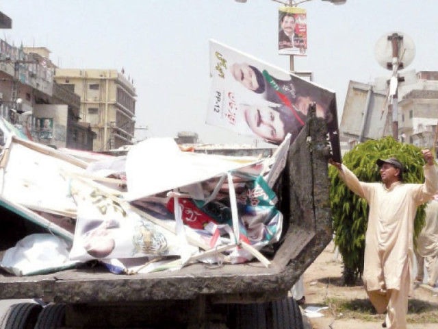 election posters of candidates are being loaded into a vehicle after getting them down in different areas of rawalpindi photo inp election posters of candidates are being loaded into a vehicle after getting them down in different areas of rawalpindi photo inp