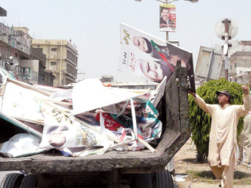 election posters of candidates are being loaded into a vehicle after getting them down in different areas of rawalpindi photo inp