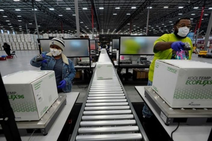 boxes containing the moderna covid 19 vaccine are prepared to be shipped at the mckesson distribution center in olive branch mississippi on december 20 2020 afp