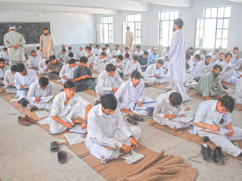 students of government boys higher secondary school sit on the floor to give their fa fsc examinations photo ghaffar baig express