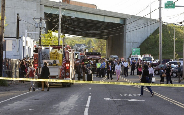 emergency personnel and onlookers gather at the scene of a collision of two commuter trains in bridgeport connecticut may 17 2013 photo reuters