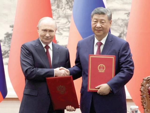 chinese president xi jinping and russian president vladimir putin shake hands during a signing ceremony at the great hall of the people in beijing photo reuters chinese president xi jinping and russian president vladimir putin shake hands during a signing ceremony at the great hall of the people in beijing photo reuters