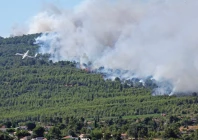 a french civil security s aircraft flies over the area as firefighters work to contain a wildfire in pouzols minervois near narbonne france photo reuters