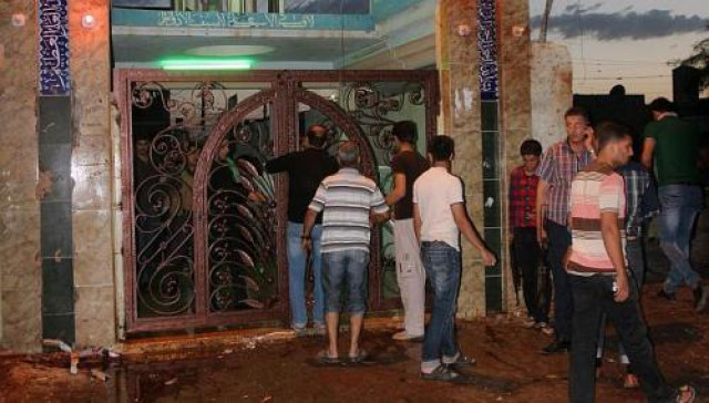 people gather outside alzahraa husseiniyah a shiite place of worship after a suicide bomb attack in the northern iraq city of kirkuk on may 16 2013 photo afp people gather outside alzahraa husseiniyah a shiite place of worship after a suicide bomb attack in the northern iraq city of kirkuk on may 16 2013 photo afp