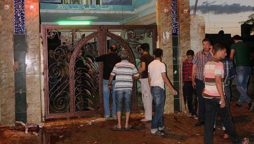 people gather outside alzahraa husseiniyah a shiite place of worship after a suicide bomb attack in the northern iraq city of kirkuk on may 16 2013 photo afp