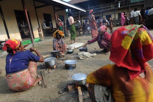 muslim rohingya women prepare their meal at a temporary relief camp on the outskirts of sittwe on may 17 2013 photo afp