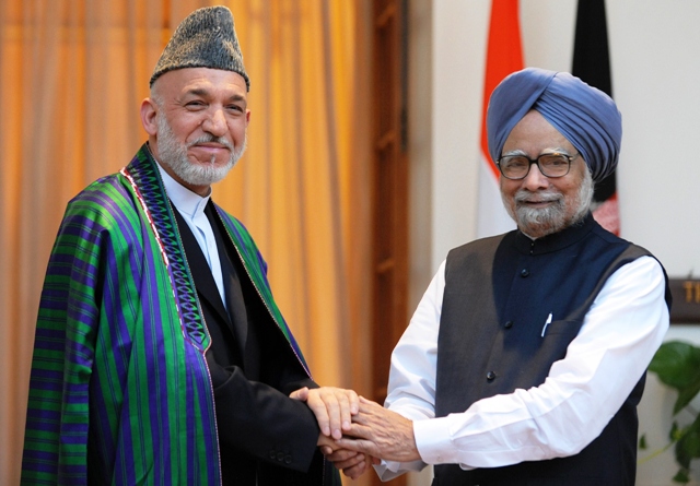 file photo of president of afghanistan hamid karzai l shaking hands with indian prime minister manmohan singh r during a meeting in new delhi photo afp file