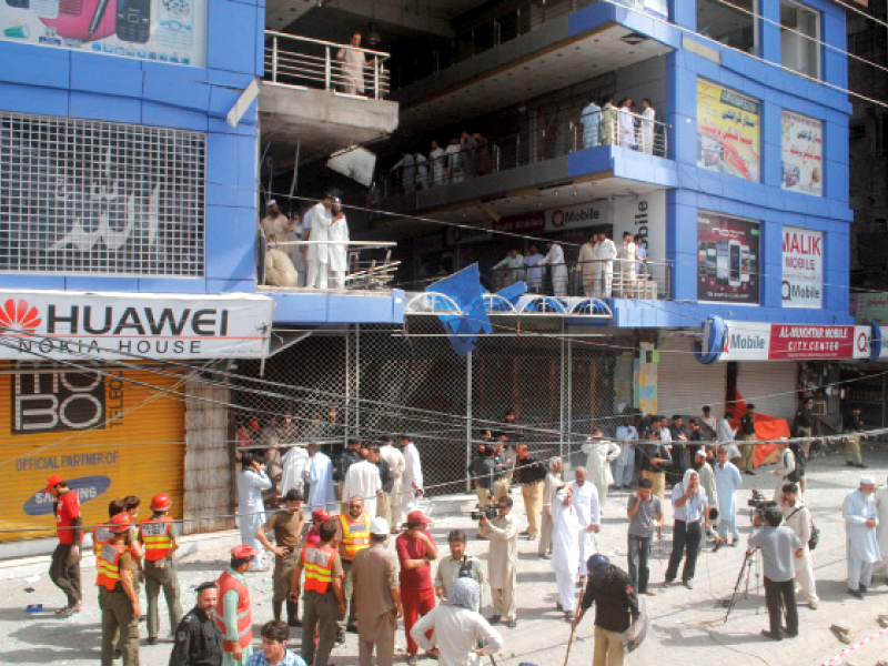 police officials declated the blast at falak ser plaza to be the result of a generator exploding shopkeepers felt it might have been a planted explosive as militants had threatened mobile shops for selling un islamic material photo muhammad iqbal express