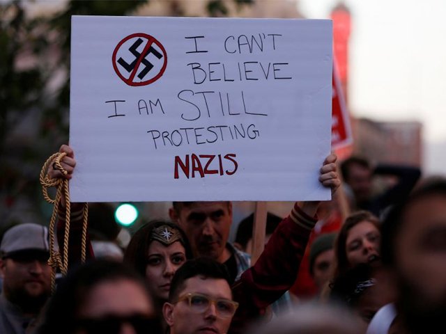 a demonstrator holds signs during a rally in response to the charlottesville virginia car attack on counter protesters after the quot unite the right quot rally organized by white nationalists in oakland california u s august 12 2017 photo reuters
