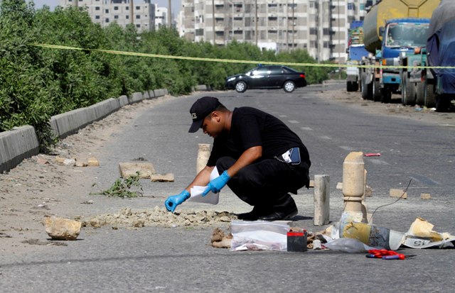 bomb disposal squad inspects evidence at the blast site in clifton block 1 near chapal resort on may 21 2013 photo athar khan express tribune