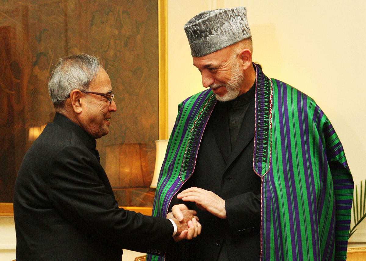 this handout photograph received from the presidential palace on may 21 2013 india president pranab mukherjee l shakes hands with afghan president hamid karzai during a meeting at the presidential palace in new delhi photo afp