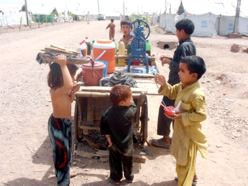 idps at the camp complain they cannot sleep at night because of mosquitoes and stay awake to fan their children photo express