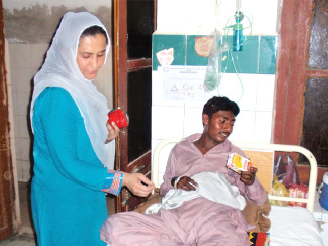 sanam fakir a candidate from ps 1 sukkur distributed juices and hand fans among the patients at the civil hospital sukkur on tuesday photo express