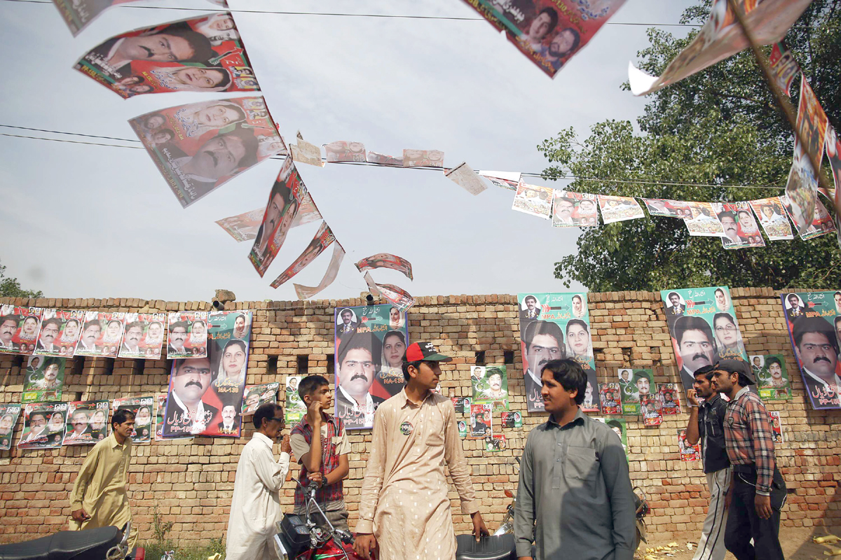 people gather near a polling station in a village near lahore may 11 2013 photo reuters