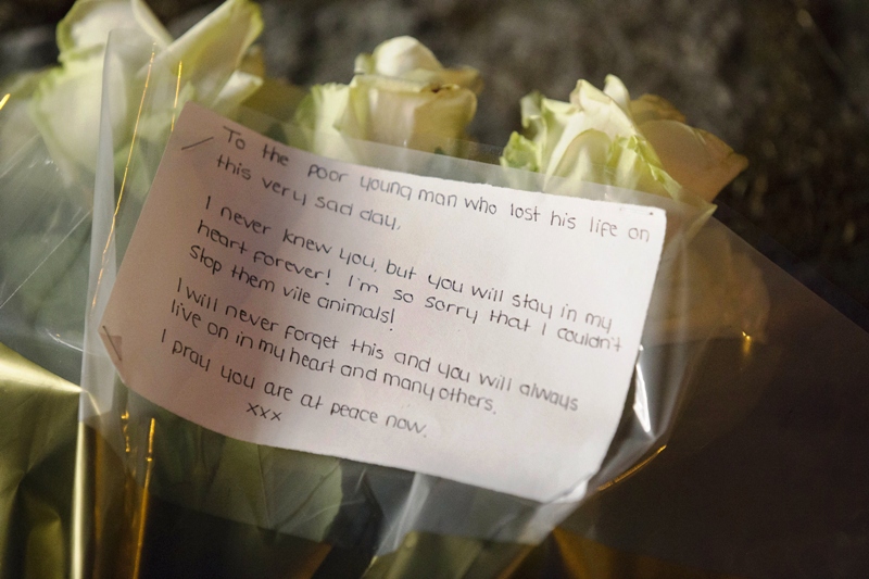 the card on a floral tribute is displayed at woolwich barracks in london on may 22 2013 after a man believed to be a serving british soldier was brutally murdered nearby in what prime minister david cameron said appeared to be a terrorist attack photo afp